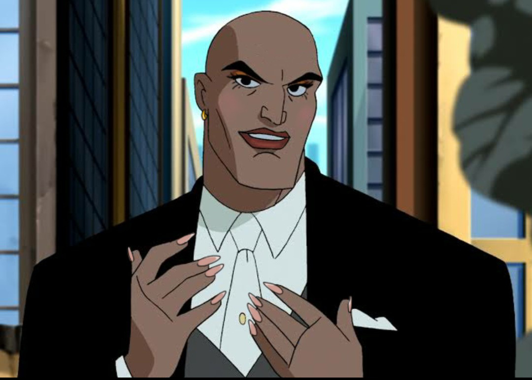 Edit of Lex Luthor from the animated Justice League tv show. He is holding his hands to his chest, displaying his long pastel pink acrylic nails. He is wearing natural-looking makeup, and has a small gold earring in his ear.